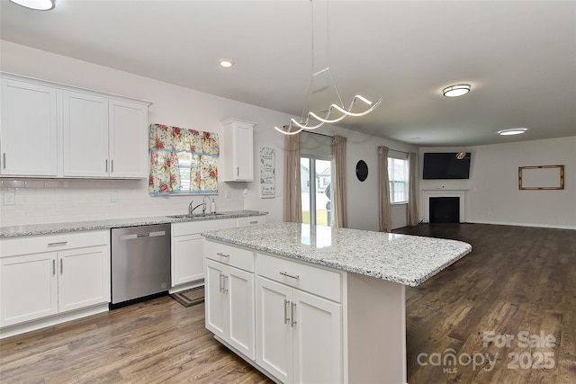 9505 Cotswood Pl, Gastonia, NC 28056 - kitchen with stainless steel dishwasher, white cabinetry, decorative backsplash, dark wood finished floors, and a center island