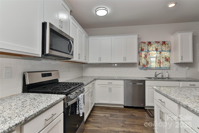9505 Cotswood Pl, Gastonia, NC 28056 - kitchen with stainless steel appliances, white cabinets, tasteful backsplash, dark wood finished floors, and light stone counters