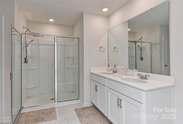 9505 Cotswood Pl, Gastonia, NC 28056 - bathroom featuring a stall shower, double vanity, recessed lighting, and tile patterned flooring