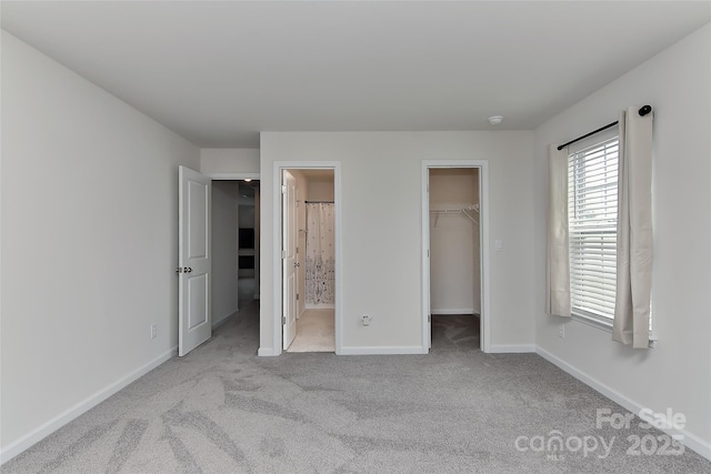 9505 Cotswood Pl, Gastonia, NC 28056 - unfurnished bedroom featuring a walk in closet, carpet flooring, a closet, and connected bathroom