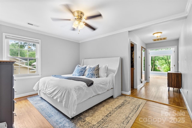 4024 Tyndale Ave, Charlotte, NC 28210 - bedroom with light wood-style flooring, multiple windows, baseboards, ornamental molding, and ceiling fan