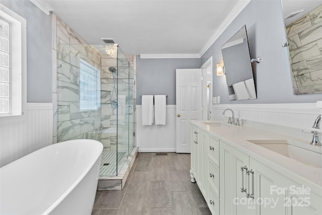 4024 Tyndale Ave, Charlotte, NC 28210 - full bath featuring a freestanding tub, a stall shower, double vanity, crown molding, and wainscoting