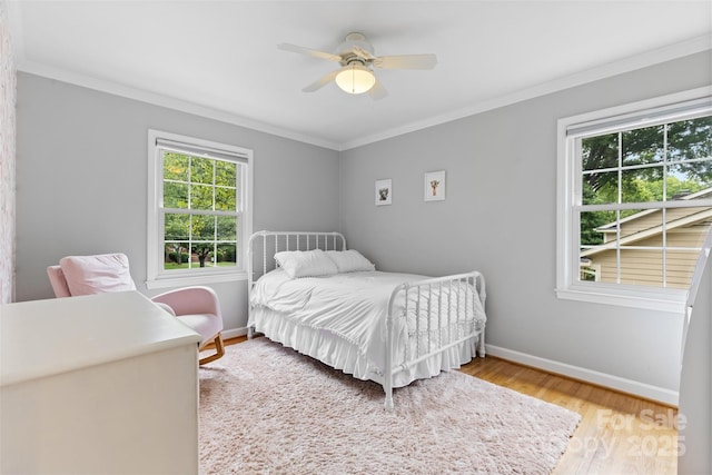 4024 Tyndale Ave, Charlotte, NC 28210 - bedroom with multiple windows, baseboards, wood finished floors, crown molding, and ceiling fan
