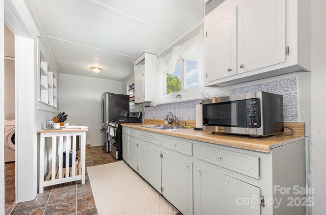 380 Woodlawn Ave, Cramerton, NC 28032 - kitchen featuring appliances with stainless steel finishes, stone finish flooring, decorative backsplash, and white cabinetry