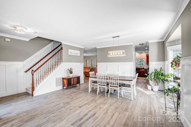 1503 Stoney Ct, York, SC 29745 - dining area with a decorative wall, stairway, light wood finished floors, a wainscoted wall, and ornamental molding