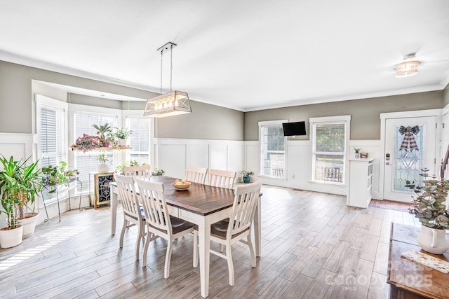 1503 Stoney Ct, York, SC 29745 - dining space featuring a decorative wall, light wood-type flooring, a wainscoted wall, and plenty of natural light