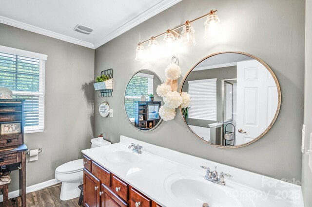 1503 Stoney Ct, York, SC 29745 - bathroom featuring wood finished floors, double vanity, toilet, crown molding, and baseboards