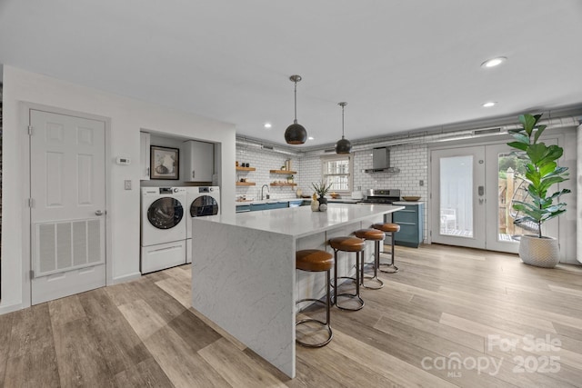 3528 Colony Rd Unit A, Charlotte, NC 28211 - kitchen featuring separate washer and dryer, open shelves, wall chimney exhaust hood, light wood-style floors, and recessed lighting