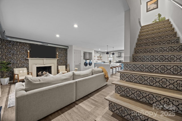 3528 Colony Rd Unit A, Charlotte, NC 28211 - living room featuring stairs, a fireplace, recessed lighting, light wood-style flooring, and washer / clothes dryer