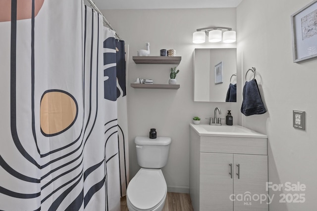 3528 Colony Rd Unit A, Charlotte, NC 28211 - full bathroom with vanity, toilet, wood finished floors, curtained shower, and baseboards