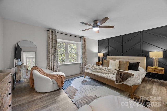 3528 Colony Rd Unit A, Charlotte, NC 28211 - bedroom with wood finished floors, ceiling fan, and a decorative wall