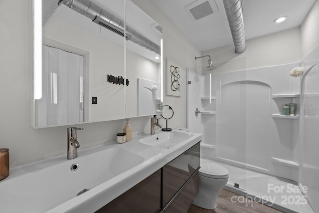 3528 Colony Rd Unit A, Charlotte, NC 28211 - bathroom featuring a walk in shower, toilet, double vanity, and wood finished floors