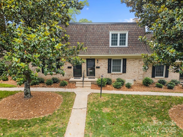 3528 Colony Rd Unit A, Charlotte, NC 28211 - view of front of house featuring mansard roof, brick siding, and a front yard