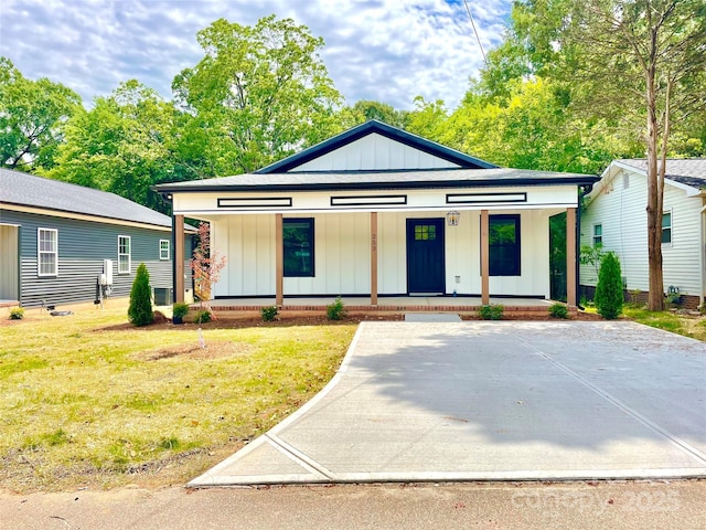 view of front of property featuring a porch, board and batten siding, and a front lawn