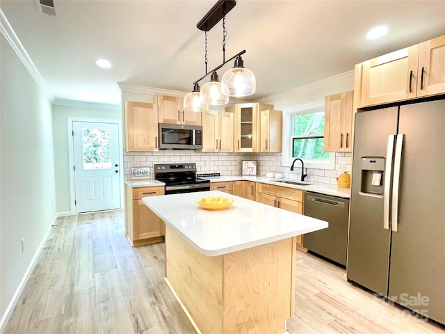 kitchen with stainless steel appliances, light brown cabinetry, crown molding, a sink, and tasteful backsplash