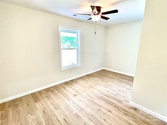 empty room featuring ceiling fan, wood finished floors, and baseboards