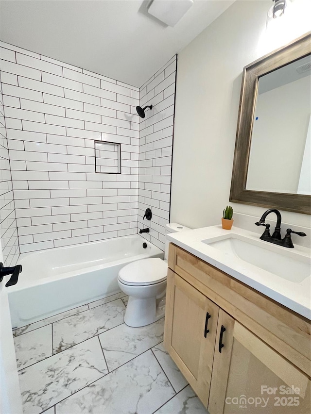 full bathroom with marble look tile flooring, toilet, vanity, and shower / bathtub combination