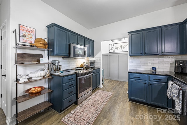 6107 Raisin Tree Ln, Charlotte, NC 28215 - kitchen featuring stainless steel appliances, blue cabinetry, and dark wood-type flooring