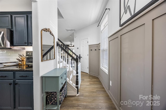 6107 Raisin Tree Ln, Charlotte, NC 28215 - foyer entrance featuring wood finished floors, stairway, and ceiling fan
