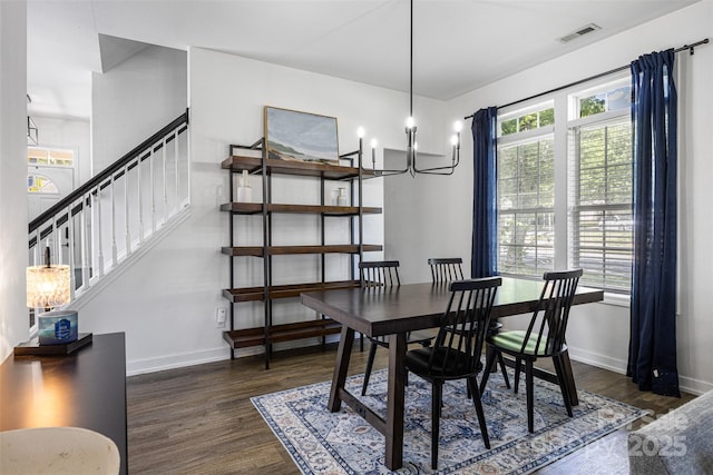 6107 Raisin Tree Ln, Charlotte, NC 28215 - dining area with wood finished floors, stairway, baseboards, and a chandelier