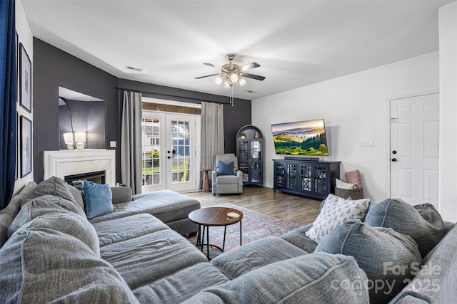 6107 Raisin Tree Ln, Charlotte, NC 28215 - living area with wood finished floors, a ceiling fan, french doors, and a high end fireplace