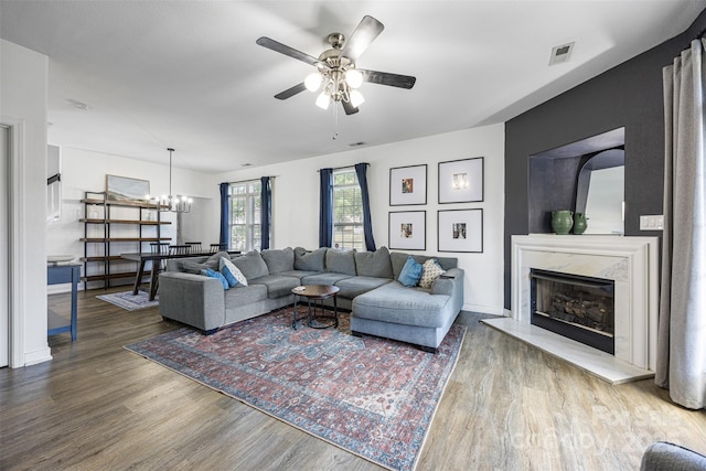 6107 Raisin Tree Ln, Charlotte, NC 28215 - living area featuring wood finished floors, ceiling fan, a high end fireplace, a chandelier, and baseboards