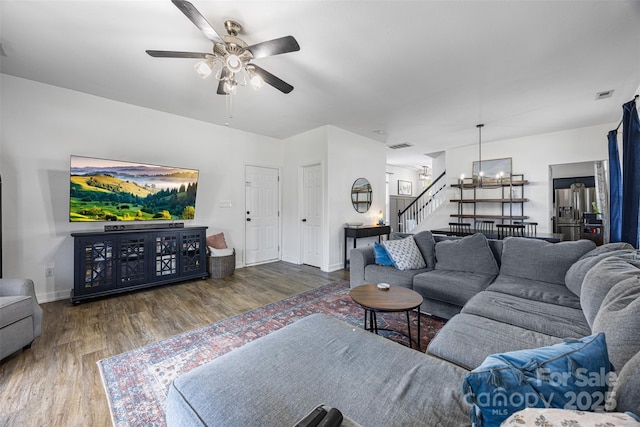 6107 Raisin Tree Ln, Charlotte, NC 28215 - living area featuring wood finished floors, stairway, ceiling fan, a chandelier, and baseboards