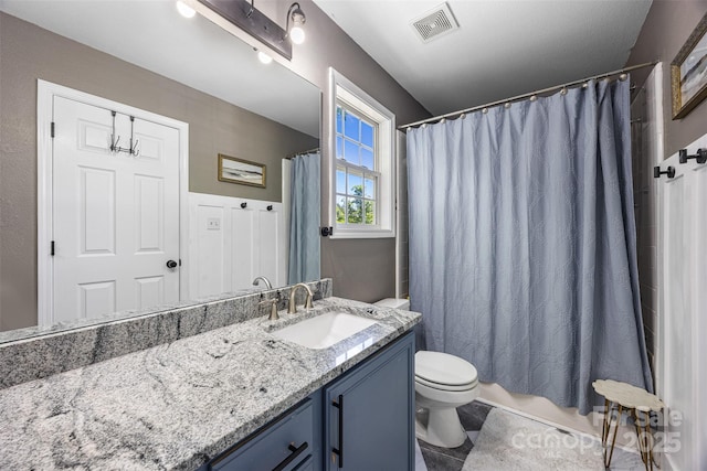 6107 Raisin Tree Ln, Charlotte, NC 28215 - bathroom featuring toilet, vanity, and shower / bath combo with shower curtain