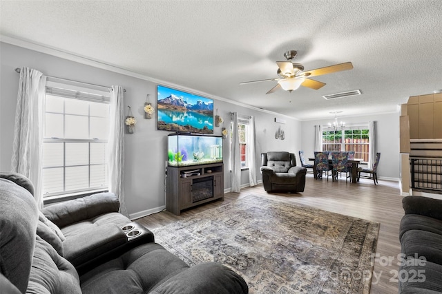 641 Saratoga Dr, Clover, SC 29710 - living room featuring a ceiling fan, a chandelier, crown molding, a textured ceiling, and light wood-type flooring