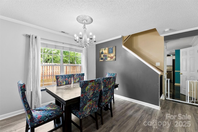 641 Saratoga Dr, Clover, SC 29710 - dining room featuring a chandelier, crown molding, wood finished floors, a textured ceiling, and baseboards