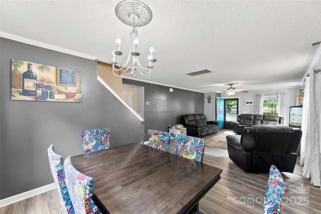 641 Saratoga Dr, Clover, SC 29710 - dining space with a textured ceiling, a chandelier, crown molding, wood finished floors, and a ceiling fan