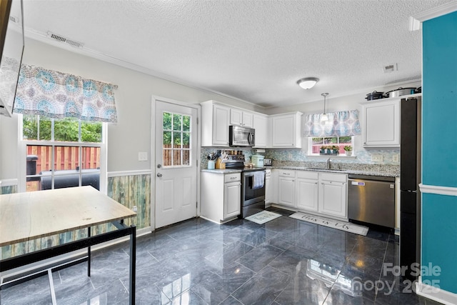 641 Saratoga Dr, Clover, SC 29710 - kitchen featuring stainless steel appliances, white cabinetry, a sink, a textured ceiling, and light stone countertops