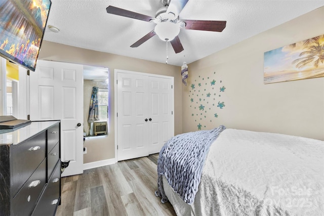 641 Saratoga Dr, Clover, SC 29710 - bedroom with wood finished floors, a closet, a textured ceiling, and ceiling fan