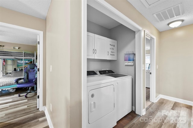641 Saratoga Dr, Clover, SC 29710 - laundry room featuring cabinet space, washing machine and dryer, light wood-style floors, and baseboards