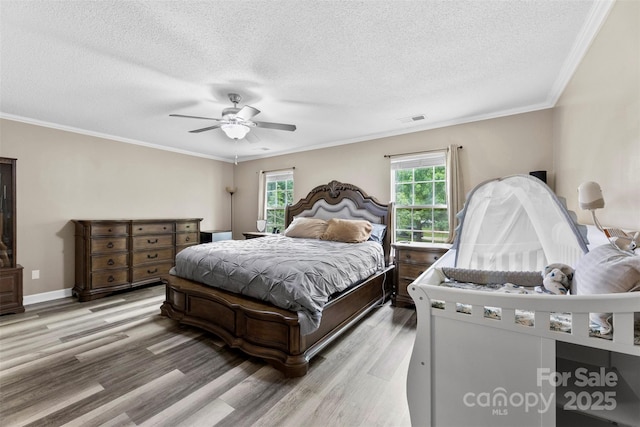 641 Saratoga Dr, Clover, SC 29710 - bedroom featuring light wood-style flooring, ornamental molding, a textured ceiling, ceiling fan, and baseboards