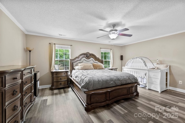 641 Saratoga Dr, Clover, SC 29710 - bedroom featuring wood finished floors, multiple windows, a textured ceiling, ornamental molding, and baseboards