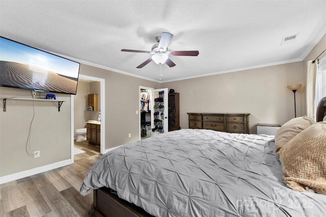 641 Saratoga Dr, Clover, SC 29710 - bedroom with wood finished floors, crown molding, ensuite bath, ceiling fan, and a walk in closet