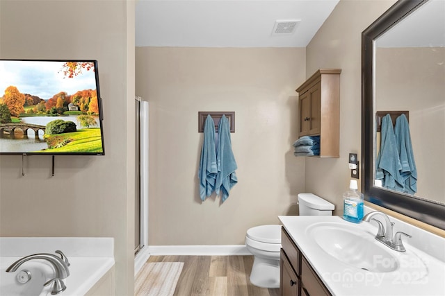 641 Saratoga Dr, Clover, SC 29710 - full bathroom featuring vanity, toilet, a bath, a stall shower, and wood finished floors