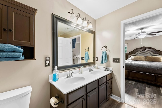 641 Saratoga Dr, Clover, SC 29710 - bathroom with double vanity, wood finished floors, ceiling fan, toilet, and ensuite bathroom