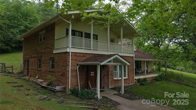 773 Peppers Creek Rd, Marion, NC 28752 - view of front of house with a balcony, covered porch, brick siding, and a front lawn