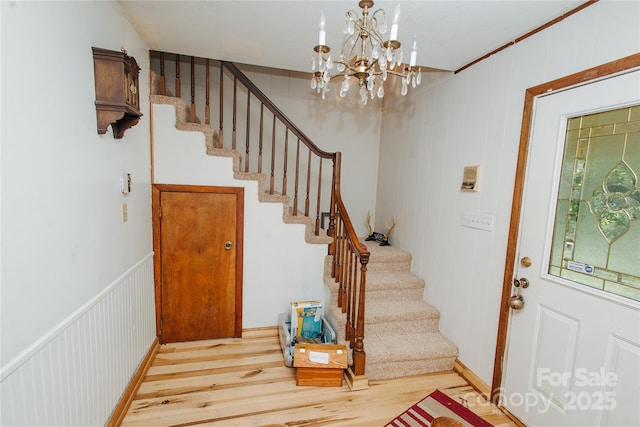773 Peppers Creek Rd, Marion, NC 28752 - entryway with wood finished floors, stairway, and a chandelier