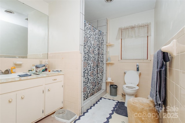 773 Peppers Creek Rd, Marion, NC 28752 - bathroom featuring tile walls, vanity, toilet, a wainscoted wall, and a shower stall