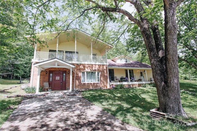 773 Peppers Creek Rd, Marion, NC 28752 - view of front of property with a balcony, a porch, brick siding, and a front yard