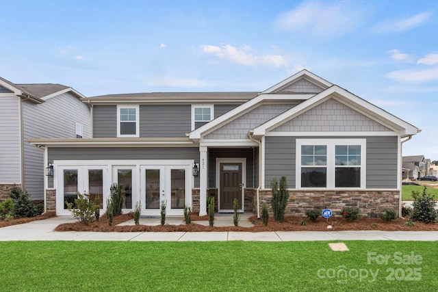 2588 Blue Sky Meadows Dr, Monroe, NC 28110 - craftsman inspired home featuring french doors, a front lawn, and stone siding