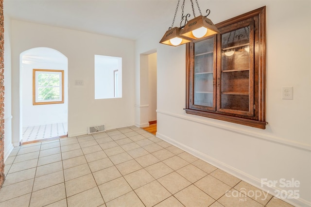 179 Brevard Rd, Asheville, NC 28806 - spare room with arched walkways and light tile patterned floors