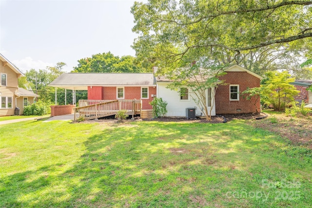179 Brevard Rd, Asheville, NC 28806 - rear view of house with central air condition unit, a wooden deck, an attached carport, brick siding, and a yard