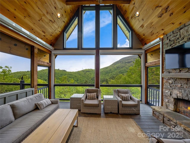 399 Toxaway Ct, Lake Toxaway, NC 28747 - sunroom with an outdoor living space with a fireplace, vaulted ceiling, and plenty of natural light