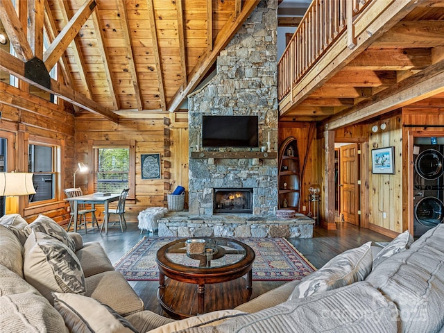 399 Toxaway Ct, Lake Toxaway, NC 28747 - living area featuring stacked washer and clothes dryer, wooden walls, high vaulted ceiling, wooden ceiling with exposed beams, and wood finished floors