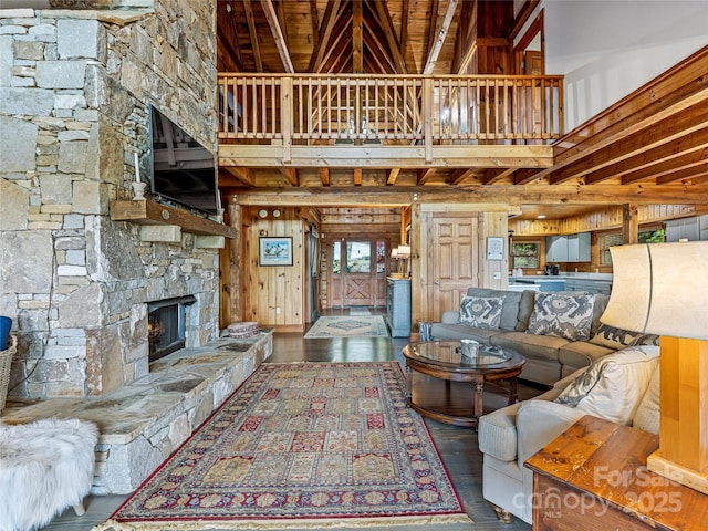 399 Toxaway Ct, Lake Toxaway, NC 28747 - living room featuring a fireplace, a high ceiling, wood-type flooring, and wood walls