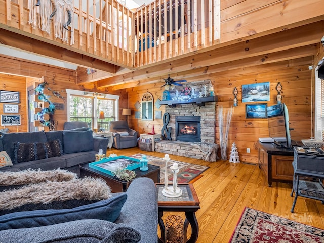 321 River Ridge Parkway, Rutherfordton, NC 28139 - living room with wood walls, wood-type flooring, a fireplace, and ceiling fan